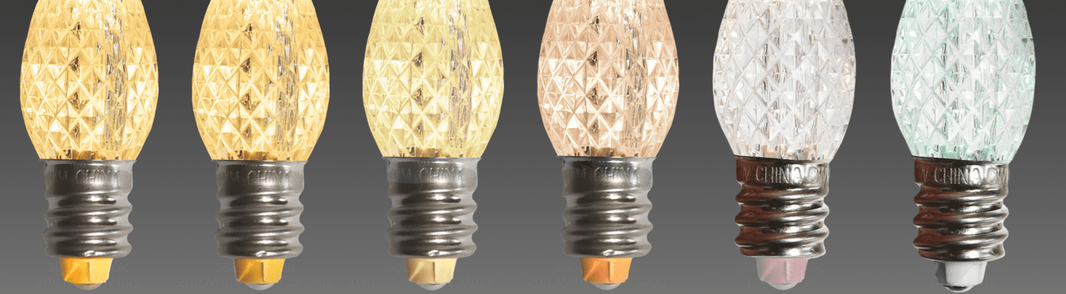 An array of Minleon C7 LED bulbs in varying shades of white, lined up side by side with visibly faceted bulbs and threaded caps.